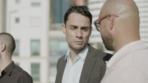 Close-up shot of carefree businessmen talking outdoor — Stockvideo