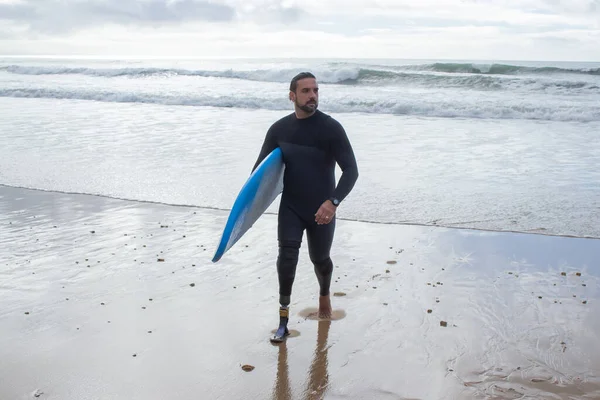 Portrait of dark-haired man training on beach alone — Stock Photo, Image