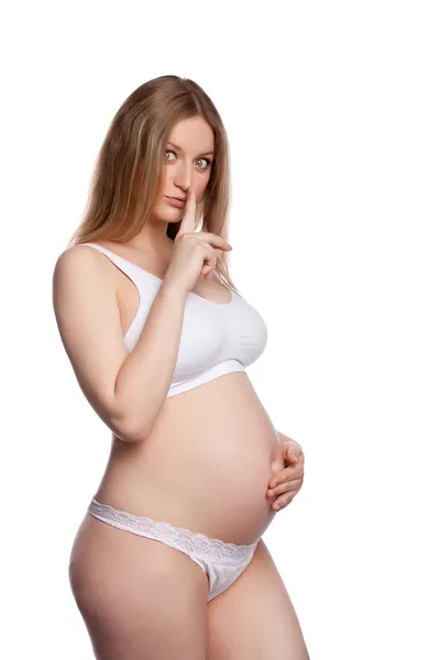 Gravid kvinna finger till hennes läppar — Stockfoto