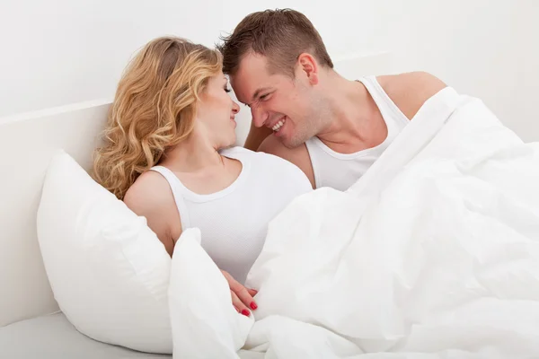 Couple lying in bed Stock Picture