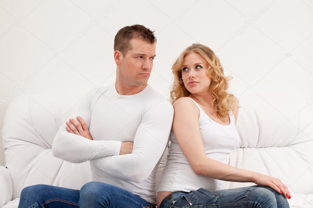 Young sad couple sitting
