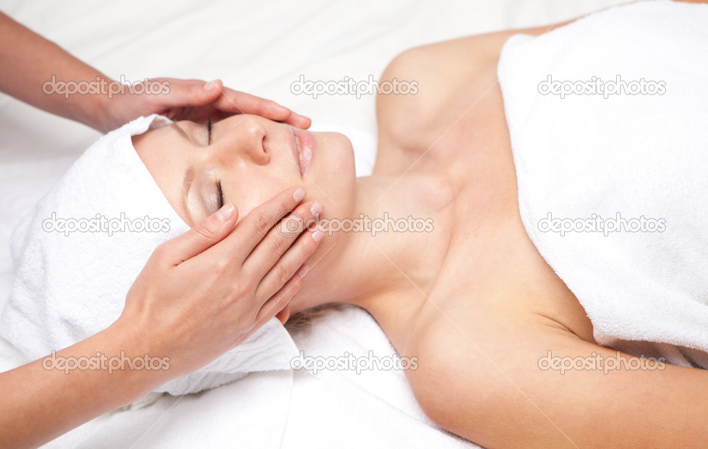 Woman getting massaging treatment over white background