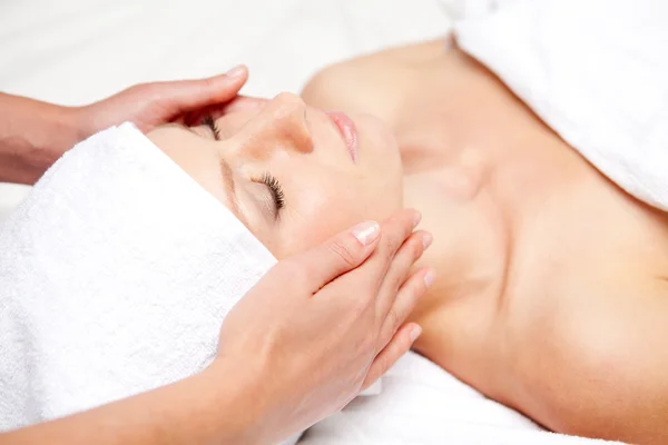 Woman getting massaging treatment over white background — Stock Photo, Image