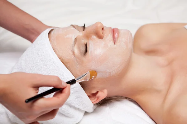 Spa therapy for woman receiving facial mask at beauty salon Stock Image