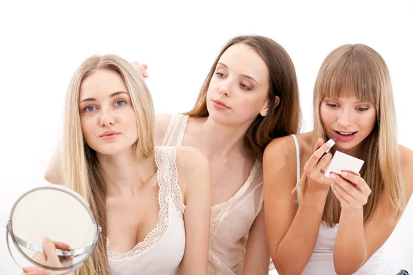 Group of women applying makeup on face — Stock Photo, Image