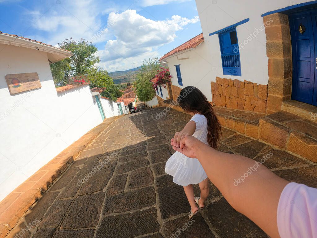 woman from behind holding hands in barichara santander