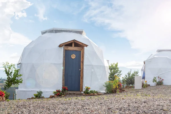 beautiful white dome with a blue door by day