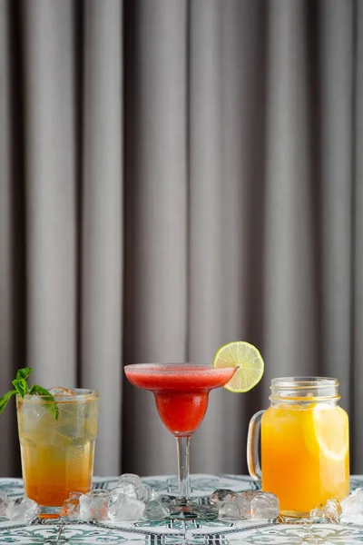 set of cocktail bar concept. three classic cocktails like a strawberry margarita, citrus lemonade.