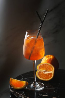 Bir bardak Aperol Spretz kokteyli mermer masa üzerinde karanlık bar konsepti..