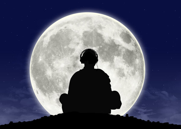Silhouette of a buddhist monk in headphones in meditation posture with the full moon on the background