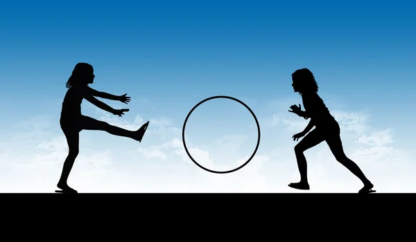 Silhouette of two girls playing with a hoop — Stock Photo, Image