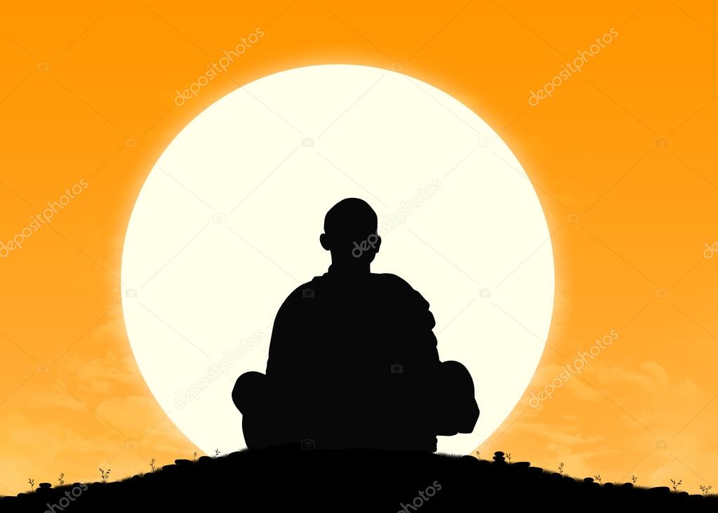 monk in meditation at sunrise
