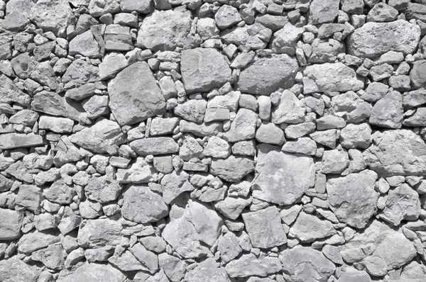 Grey old wall made of big and little stones — Stock Photo, Image