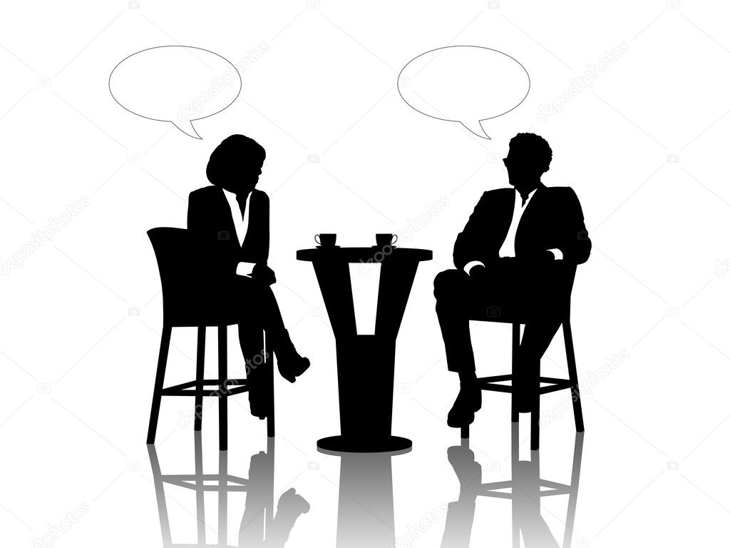 Businessman and businesswoman speaking at the table drinking cof