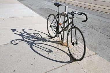Bicycle locked up on the street in Toronto clipart