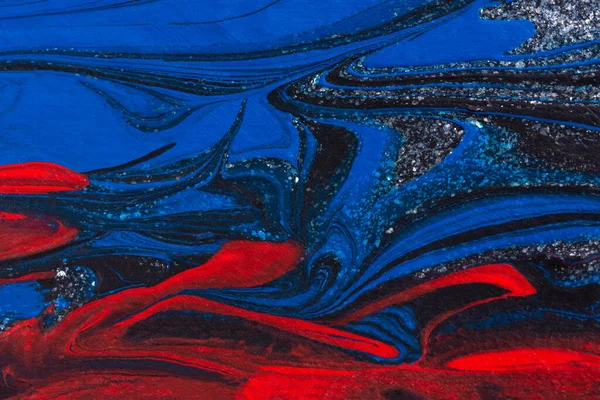 Red, black, blue acrylic fluid art, abstract creative Christmas background. Artistic bright futuristic background. Dynamic lines, water movement, splash. Design of holiday cards. Marble trendy texture