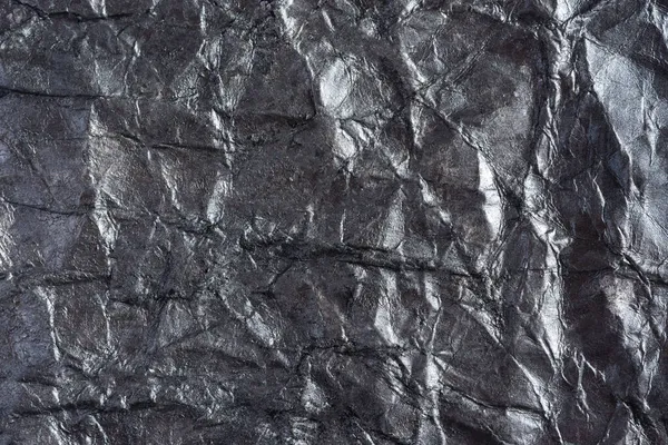 Kağıt gümüş buruşuk arka plan. Metin, kapak, web pankartı ve logo tasarımı için buruşmuş kağıttan yapılmış soyut bir arkaplan. Katı renk, desenli desen, gri arkaplan, kopyalama alanı