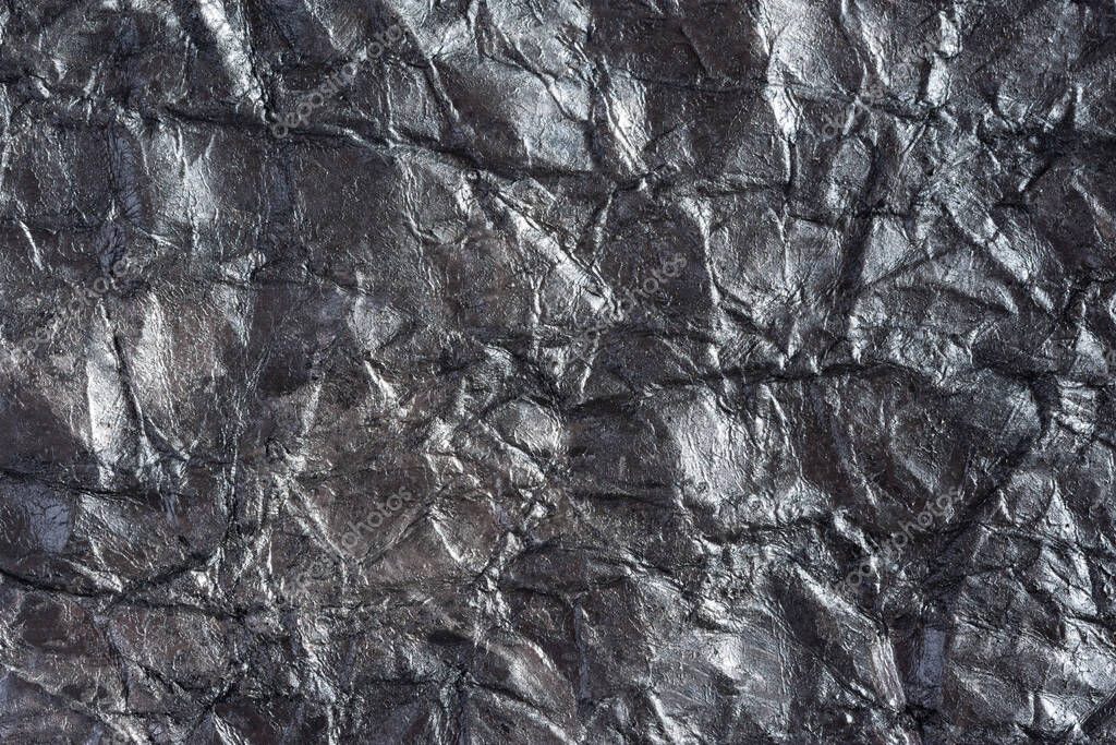 Paper silver wrinkled background. Abstract background made of crumpled paper for the design of texts, covers, web banners, logos. Mockup in solid color, textured pattern, gray background, copy space