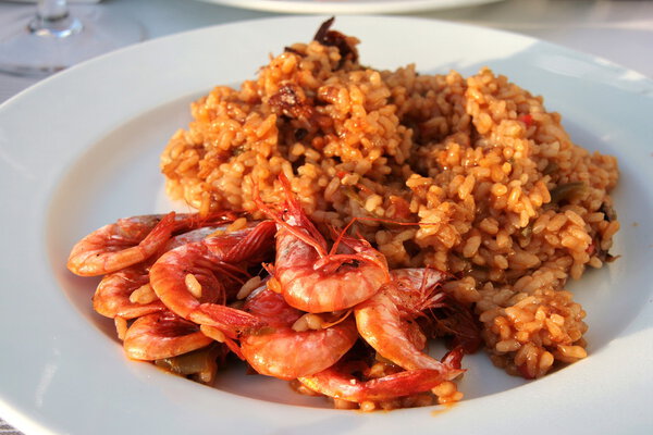 Barcelona: delicious seafood paella with shrimps, in a lovely mo