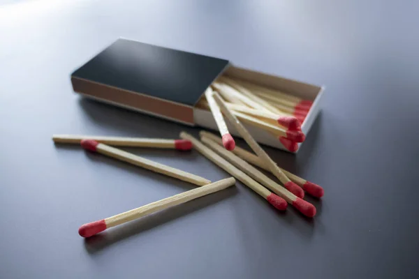 wooden matches for lighting in a cardboard sliding box