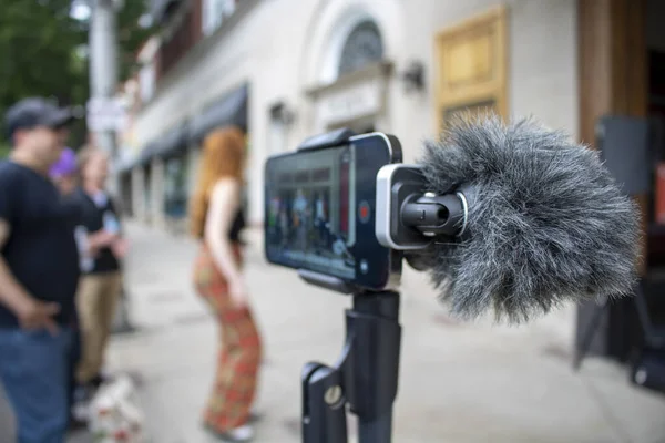 Digital Cardioid Microphone on smartphone recording band with a typhoid while groupies dance