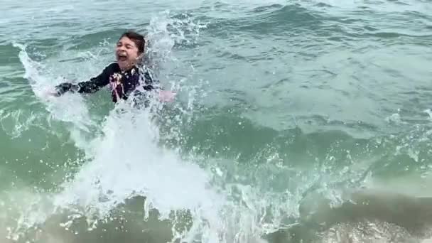 Female Child Playing Sea Gets Surprised Wave Crashing Her — Stock Video