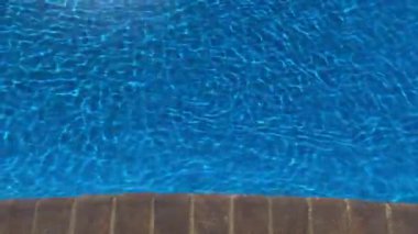 Mavi yeraltı havuzu, rüzgarlı ve güneş ışığıyla dalgalı sular. Yeraltı havuzunda mavi dalgalar