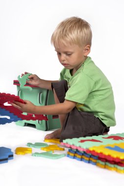 Children at play with set of rubber foam toys clipart