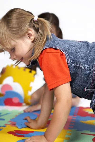 Children at play with set of rubber foam toys — Stock Photo, Image