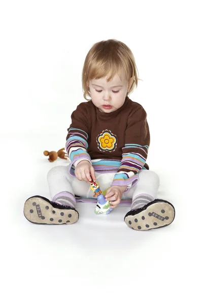 Little girl playing with toys — Stock Photo, Image