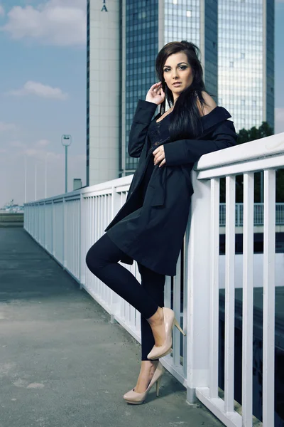 Vacker ung brunett dam poserar på staden — Stockfoto