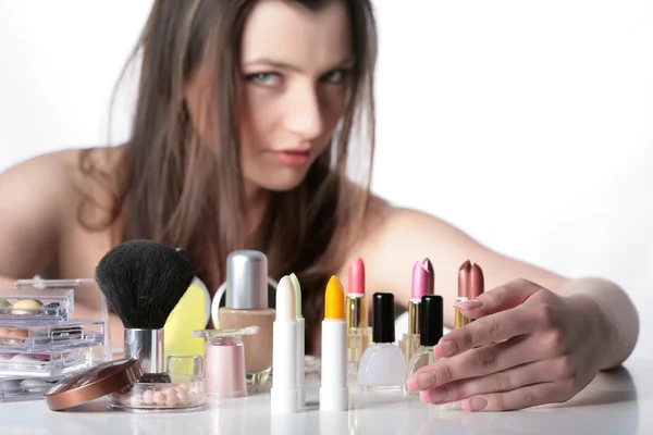 Lady with some pieces of cosmetics — Stock Photo, Image