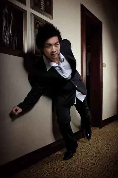 Young Asian man posing in hotel — Stock Photo, Image