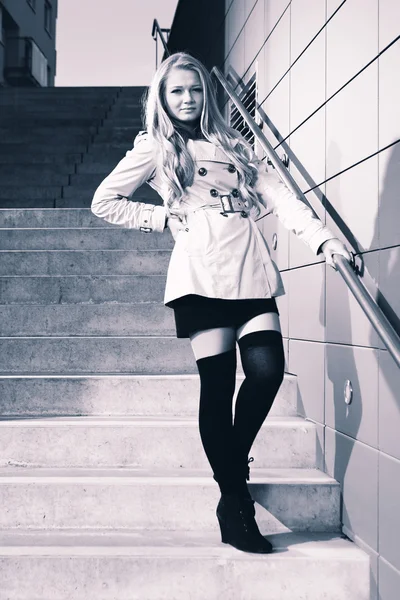 Young blonde beautiful lady on city stairs posing for beauty shots — Stock Photo, Image