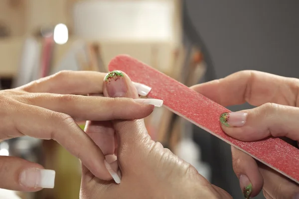 Filing nails in studio — Stock Photo, Image