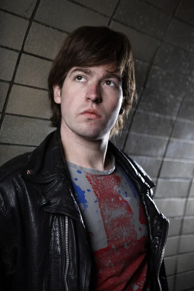 Young man posing on various city industrial locations — Stock Photo, Image