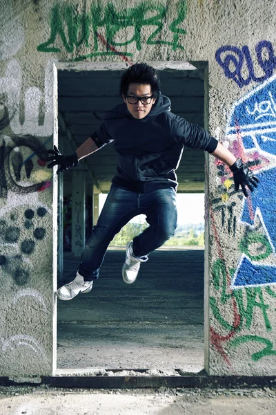 Young Asian boy posingfor stylish photos in ruins of building — Stock Photo, Image