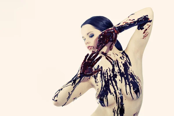 Woman tasting liquid chocolate — Stock Photo, Image