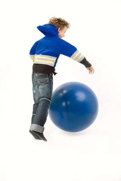 Boy playing with exercise ball Royalty Free Stock Photos