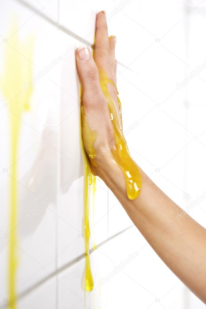 Hand in yellow slime