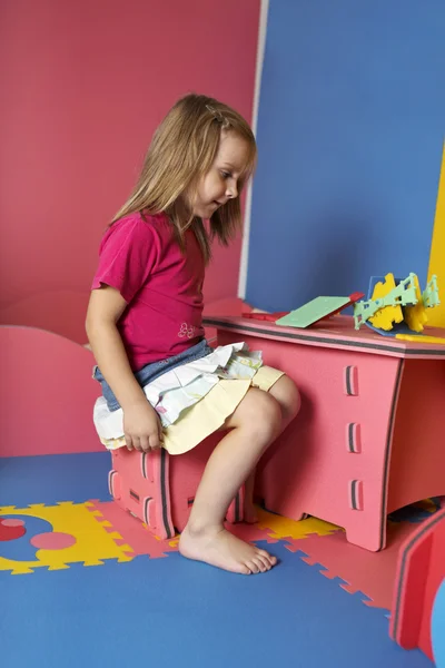 Girl playing with color rubber foam toys — Stock Photo, Image