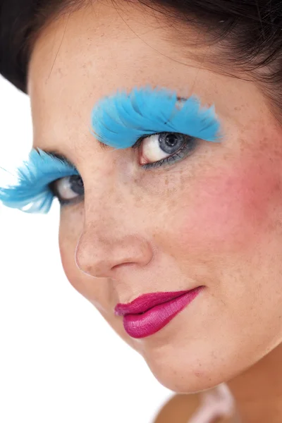 Lady posing in studio for portrait with blue feather eye lashes — Stock Photo, Image