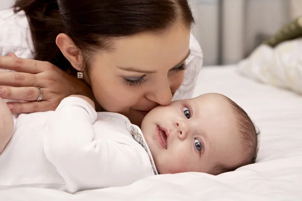 Mother taking care for her baby Stock Image