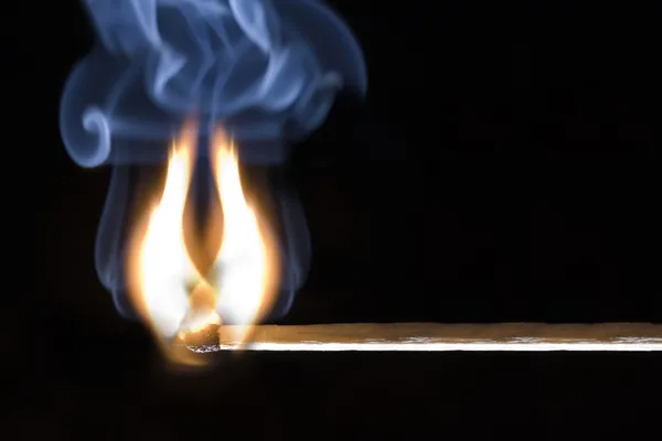 Burning match on a black background — Stock Photo, Image