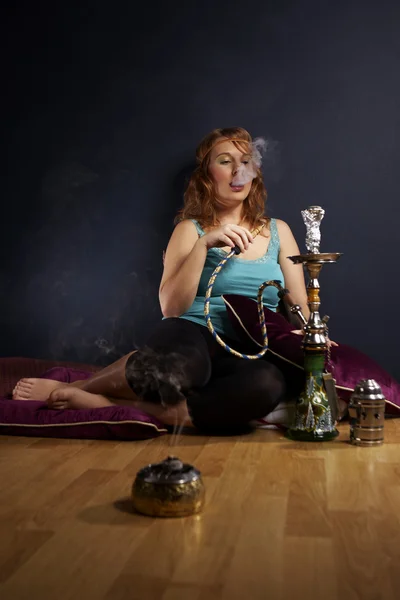 Mladá žena kouření hookah — Stock fotografie