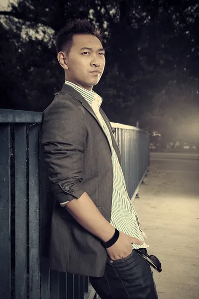 Asian man posing on the bridge — Stock Photo, Image