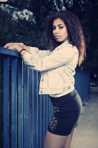 Brunette girl posing on the bridge — Stock Photo, Image