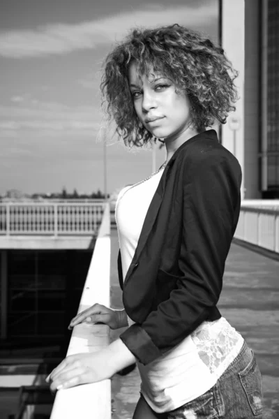 Curly girl posing on the bridge — Stock Photo, Image