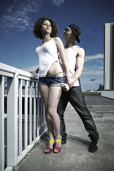 Couple posing on a bridge in city — Stock Photo, Image