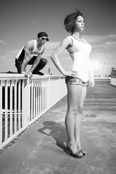 Couple posing on a bridge in city — Stock Photo, Image